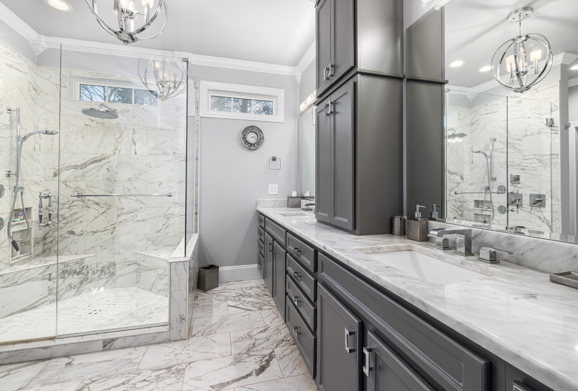 A bathroom with two sinks , a walk in shower , and a large mirror.